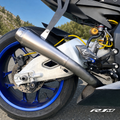 Yamaha YZF-R1M clean titanium muffler side close-up outdoors