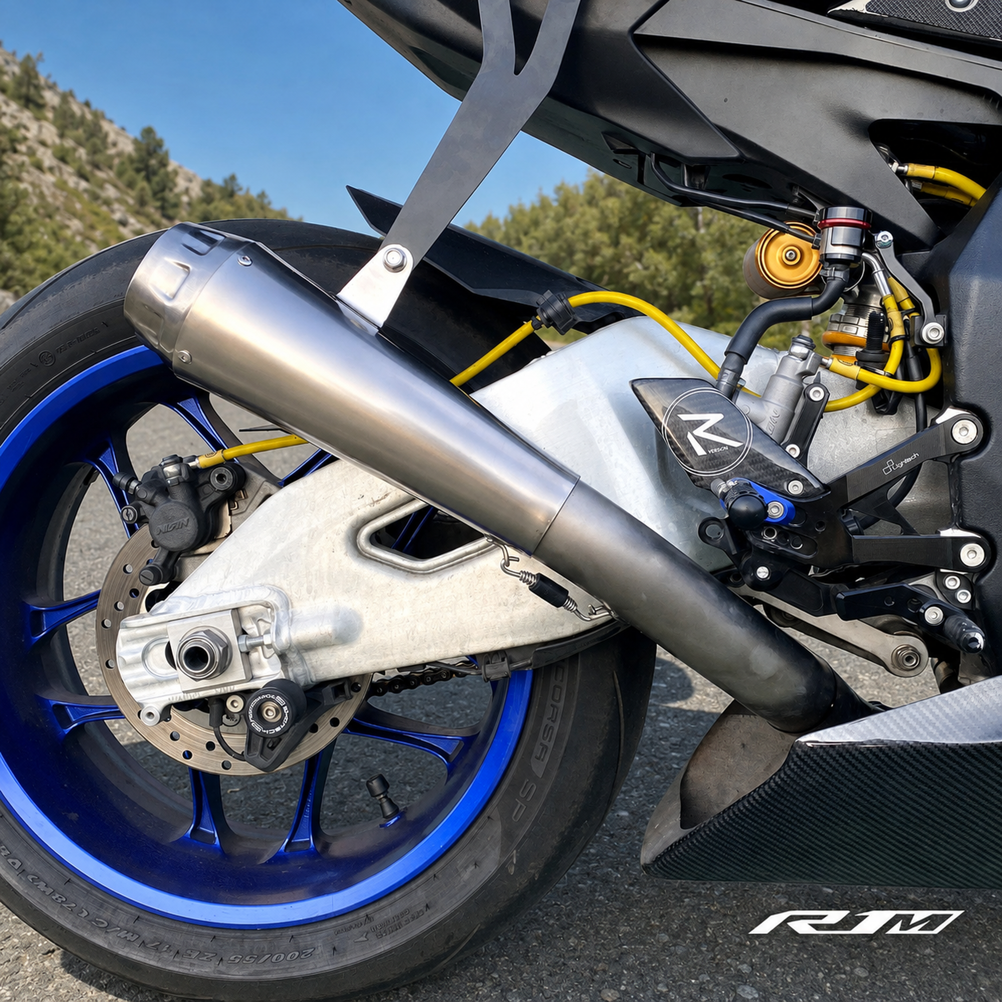 Yamaha YZF-R1M clean titanium muffler side close-up outdoors